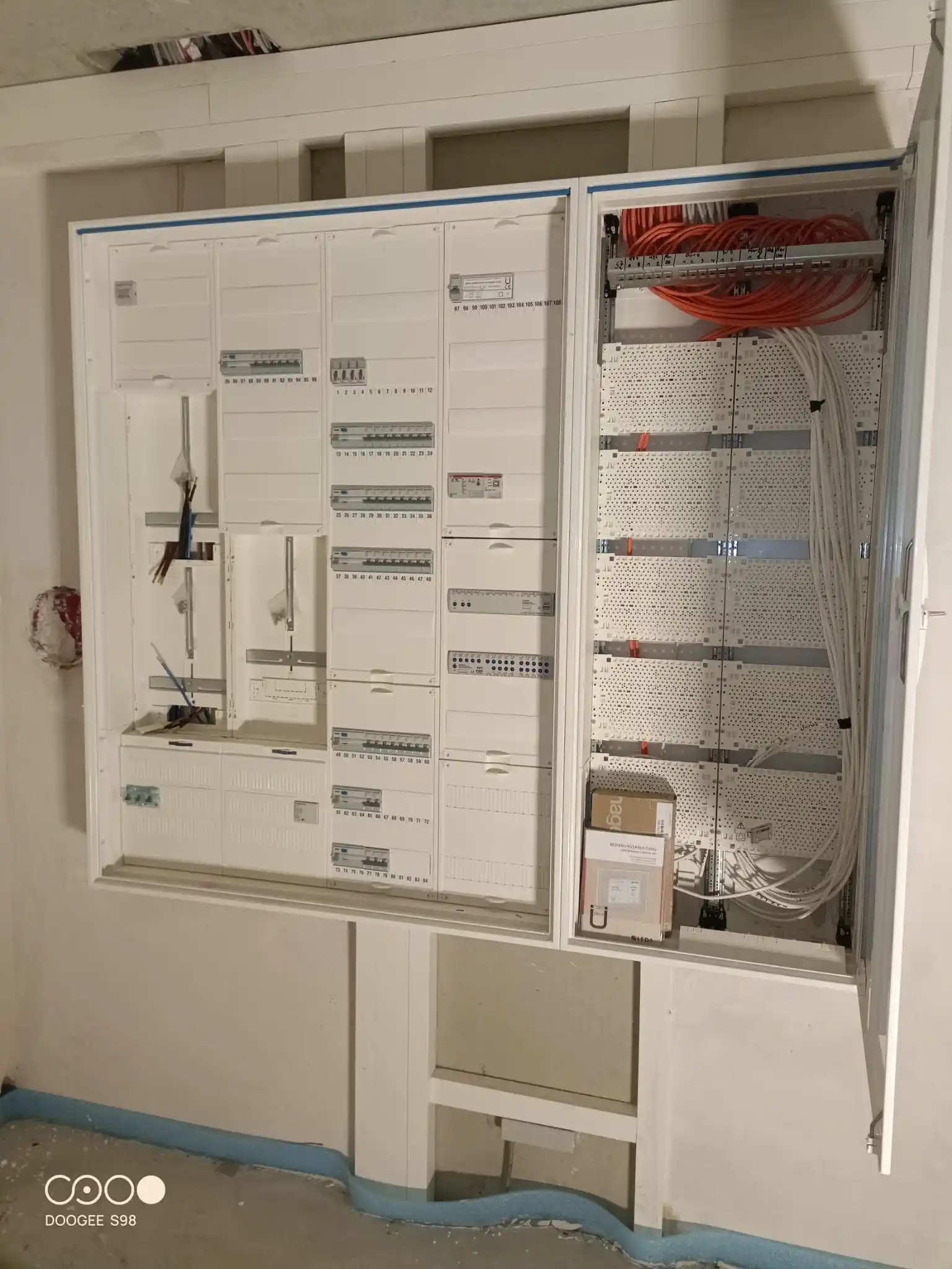 Elektroinstallation im Rohbau: Kabel und Leerrohre an der Betonwand vor dem Verputzen.